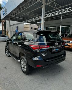 a black car parked in front of a building