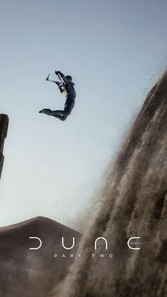 a man flying through the air while riding skis on top of a snow covered slope