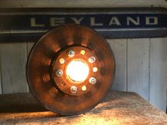 a light that is on top of a wooden table in front of a sign with the name lelyland