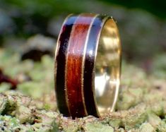 a wooden ring sitting on top of a rock