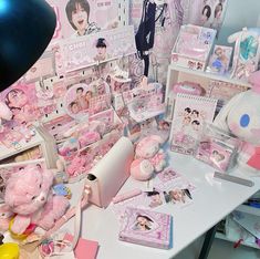 a desk with many items on it including teddy bears and other stuff animals in pink colors