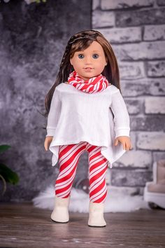 the doll is wearing red and white striped leggings