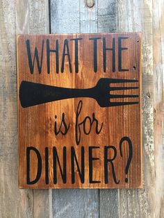 a wooden sign that says, what the is for dinner? with a fork on it