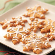 a white plate topped with cut out snowflake cookies