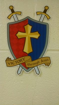 the emblem for victory through jesus is shown on a wall in a room with white tiles