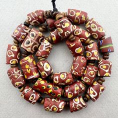 a beaded necklace with red and yellow beads