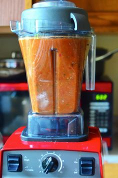 a blender filled with liquid sitting on top of a counter