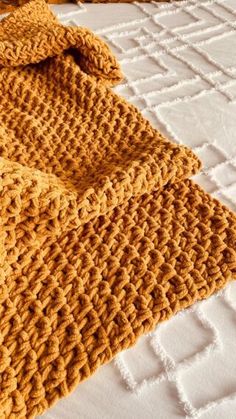 a crocheted blanket laying on top of a bed