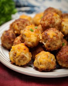 a white plate topped with meatballs covered in cheese