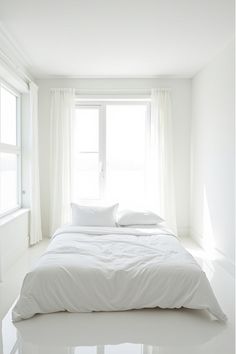 Bright white minimalist bedroom showcasing spatial design Create Space