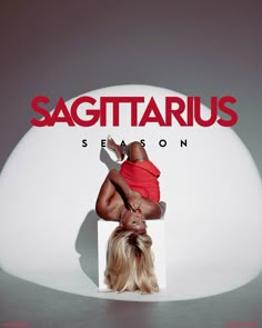 a woman sitting on top of a white chair in front of a sign that says sagittarius