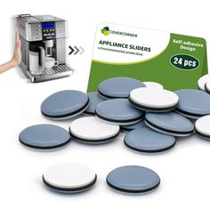 a person is holding up a card next to some appliance coasters and a coffee machine