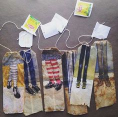 four pieces of paper with clothes hanging from them and some tags attached to the strings