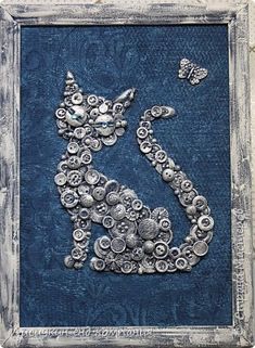 a cat made out of buttons in a frame