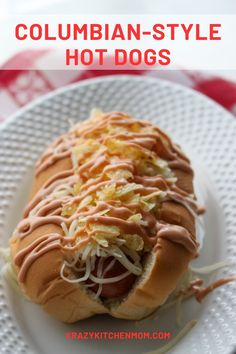 a hot dog on a plate with coleslaw and mustard drizzled over it