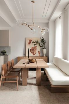 a living room with a couch, table and chairs