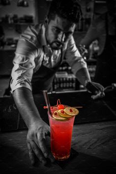 a man is preparing a drink at the bar - stock photo - images, black and white