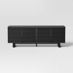 the sideboard is made out of black wood and has three horizontal slats on each side