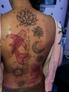 the back of a woman's body with tattoos on it