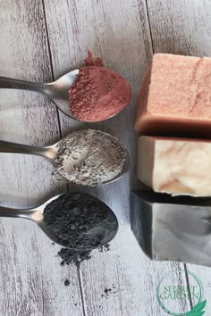 three spoons with different types of soap and powder in them on a white wooden surface