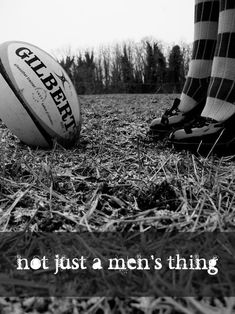 a person standing next to a rugby ball on top of a grass covered field with the words, not just a men's thing