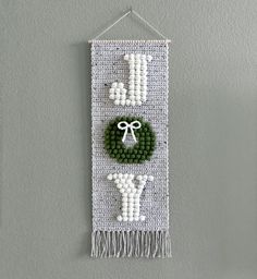 a wall hanging with beaded decorations on it