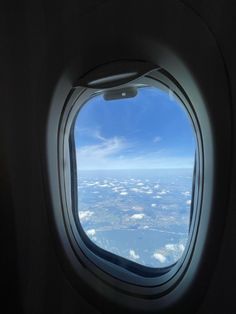 an airplane window looking out at the sky