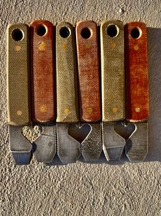 five knives are lined up in a row on the floor next to each other with heart shaped handles