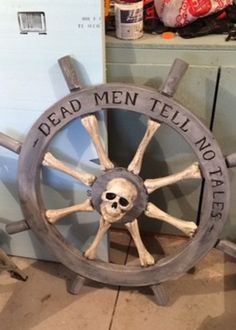 a wooden steering wheel with a skull on the spokes and words that read dead men tell no tales