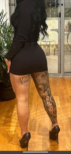 a woman with tattoos on her legs and heels