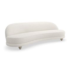 a white couch sitting on top of a wooden table