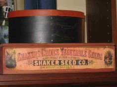 an old shaker's choice vegetable seed sign sits on top of a shelf