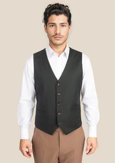 Complete your ensemble with our premium Dark Green Twill Vest. Cut from luxurious Super 110s 100% merino wool by Vitale Barberis Canonico, this custom-made vest adds the final touches to an elegantly classic style. Perfect for any occasion, feel as good as you look. Elegant Slim Fit Business Casual Vest, Elegant Slim Fit Vest For Business Casual, Elegant Black Slim Fit Vest, Elegant Sleeveless Three-piece Suit For Semi-formal Occasions, Tailored Elegant Vest For Work, Elegant Tailored Vest For Work, Luxury Black Vest For Workwear, Elegant Slim Fit Sleeveless Vest, Elegant Semi-formal Sleeveless Vest