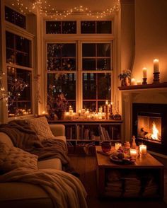 a living room filled with furniture and lit candles