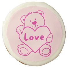 a pink teddy bear with the word love on it