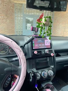 the interior of a car is decorated with pink and green decorations