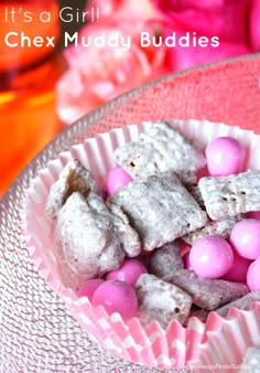 pink and white candies are in a glass bowl