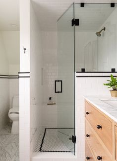 a white bathroom with black and white accents