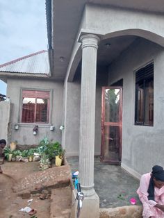 a woman sitting on steps in front of a house