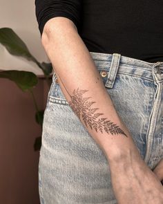 a woman's arm with a tattoo on the left side of her right arm