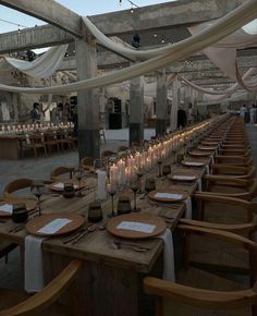 a long table is set with candles and place settings