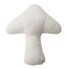 a white mushroom shaped pillow sitting on top of a table