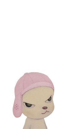 a small stuffed animal with a pink hat on it's head and eyes closed