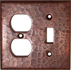 an old metal outlet cover with two holes in the middle and one light switch plate