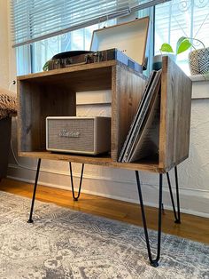 an old record player is sitting on top of a shelf