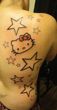 a woman with a hello kitty tattoo on her back and stars all around her body