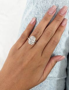 a woman's hand with a diamond ring on it