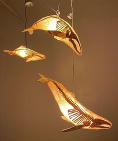 three light fixtures hanging in the shape of fish