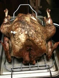 a whole chicken sitting on top of a metal rack