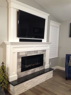 a fireplace with a flat screen tv above it